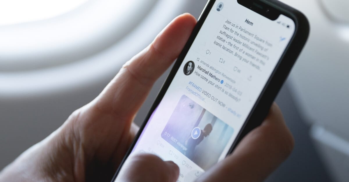 Twitter on the screen of a phone that someone is holding